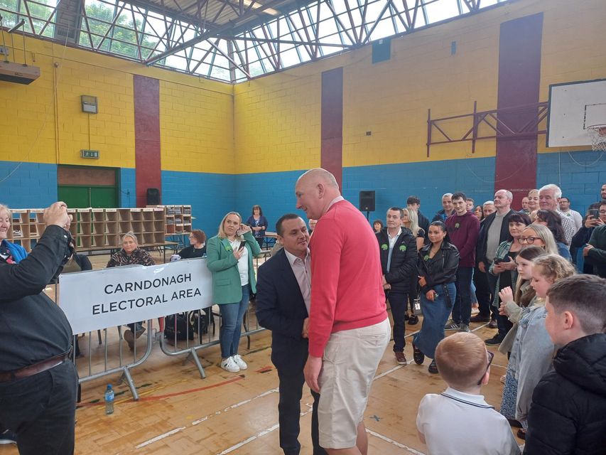 Ali Farren and Martin McDerrmott embrace after being elected in Carndonagh.