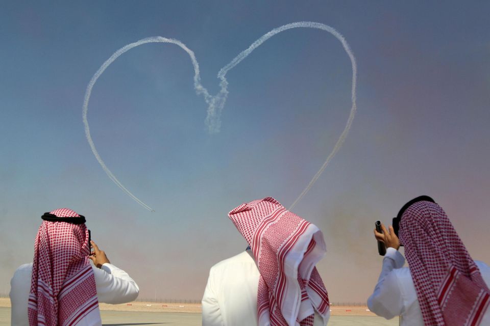 Ireland is home to a thriving ecosystem of 250 aviation and aerospace companies. Pictured, visitors take pictures as the Al Fursan aerobatic team of the UAE Air Force performs during the Dubai Airshow in 2017. Photo: Satish Kumar/Reuters