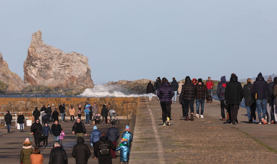 People make the most of the brisk post Christmas conditions along the harbour wall in Howth Co. Dublin   Picture; Gerry Mooney