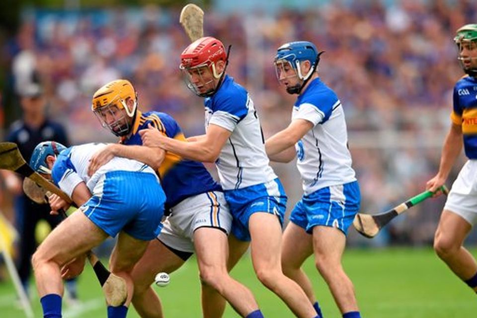 Waterford players, from left, Michael Walsh, Eddie Barrett and Colin Dunford in action against Tipperary's Kieran Bergin and James Woodlock, right