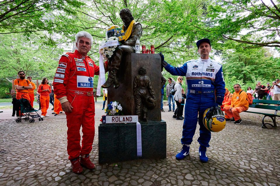 Two fans pose near the monument dedicated to Ayrton Senna during an event to commemorate the 30th anniversary of Ayrton Senna's death at Autodromo Enzo e Dino Ferrari  in Imola, Italy. Brazilian F1 racing driver Senna and Roland Ratzenberger of Austria both lost their lives in crashes at the 1994 San Marino Grand Prix. Photo: Emmanuele Ciancaglini/Getty Images