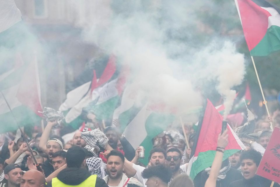 People wave Palestinian flags during a Pro-Palestinian demonstration for excluding Israel from Eurovision (Martin Meissner/AP)