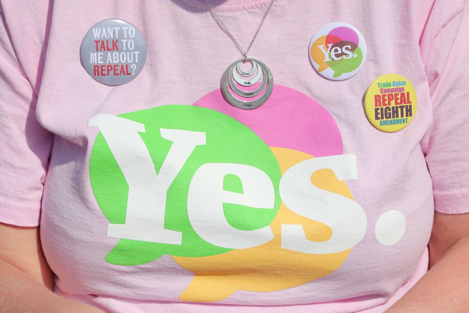 Yes badges on the T-Shirt of Liz Crummie, as the result is announced at Dublin Castle (Niall Carson/PA)