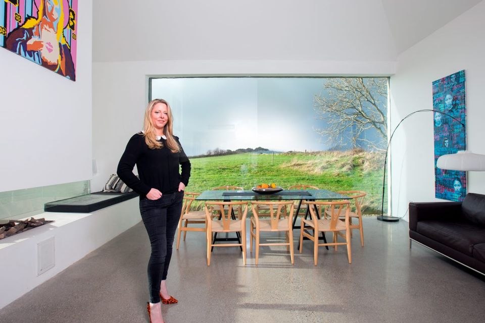Entrepreneur Louise McGuane in the dining room, which has a 32ft-high ceiling and a massive expanse of glass, affording stunning views of the countryside and sky. Photo: Tony Gavin.