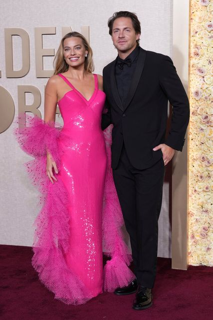 Margot Robbie, left, and Tom Ackerley arrive at the 81st Golden Globe Awards on Sunday, Jan. 7, 2024, at the Beverly Hilton in Beverly Hills, Calif. (Photo by Jordan Strauss/Invision/AP)