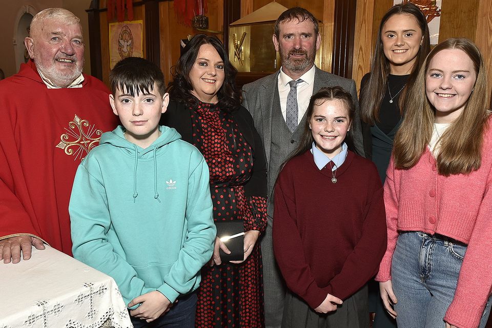 Niamh Tomkins with the V Rev. Joseph Power PP and her family.