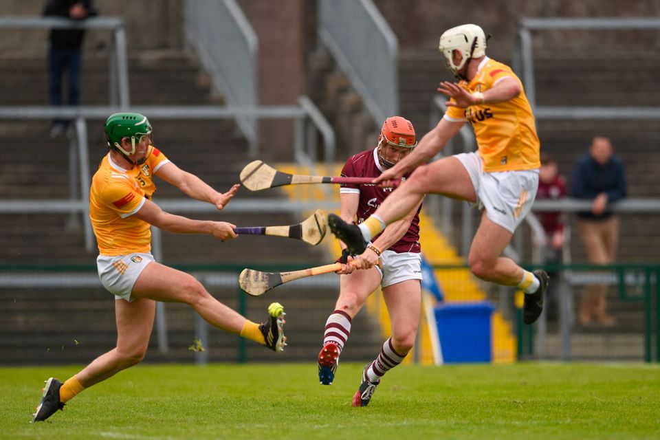 Conor Whelan of Galway shoots to score his side’s second goal despite the attempts of Gerard Walsh, left, and Paddy Burke of Antrim during the Leinster GAA Hurling Senior Championship Round 4 match at Pearse Stadium in Galway. Photo by Tom Beary/Sportsfile
