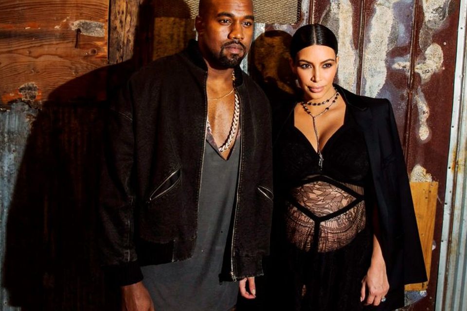 Musician Kanye West stands with his wife Kim Kardashian after watching the Givenchy Spring/Summer 2016 collection during New York Fashion Week