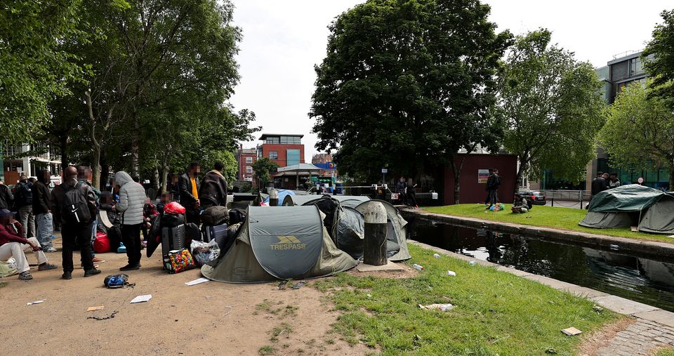 Migrants pictured in the camp along the Grand Canal.  Photo: Gerry Mooney