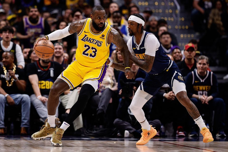Los Angeles Lakers forward LeBron James (23) controls the ball as Denver Nuggets guard Kentavious Caldwell-Pope (5) covers