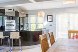 thumbnail: Open-plan kitchen and dining room with a curved breakfast bar