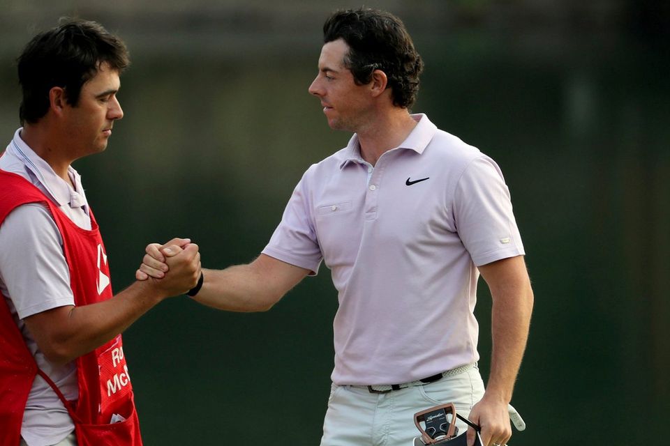 Rory McIlroy of Northern Ireland shakes hands with his caddy after finishing the 18th hole during day three of the HSBC Champions golf tournament held at the Sheshan International Golf Club in Shanghai on Saturday, Nov. 2, 2019. McIlroy spun a wedge down to 3 feet for birdie on his final hole for a clean card at a 5-under 67, giving him a one-shot lead over Louis Oosthuizen on a Saturday of big runs and ugly collapses. (AP Photo/Ng Han Guan)