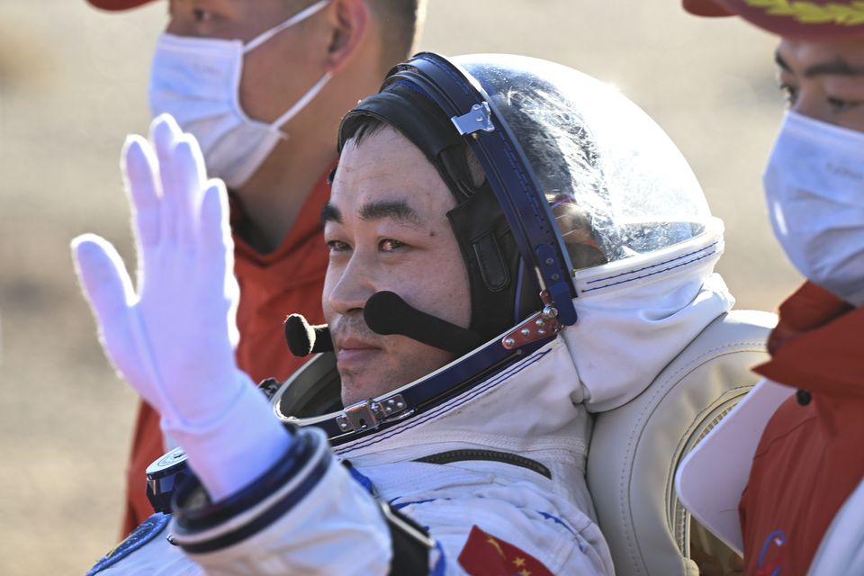 Chinese astronaut Tang Shengjie waves after returning to Earth (Bei He/Xinhua via AP)