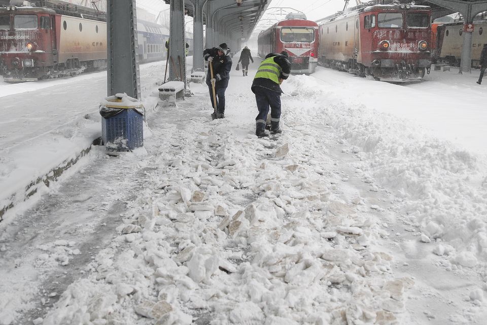 Municipal workers clear ice and snow from the platforms of the Gara de Nord, the main railway station in Bucharest, Romania (Vadim Ghirda/AP)