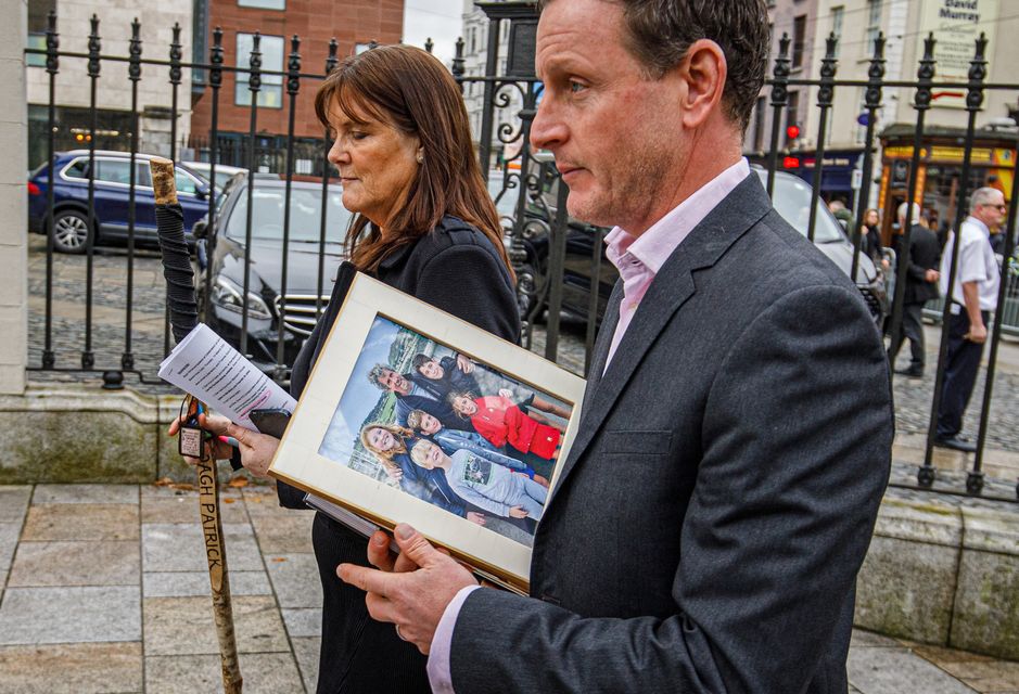 A framed picture, as well as the stick Charlie Bird used climbing Croagh Patrick, are brought to his memorial service at the Mansion House, Dublin. Photo: Mark Condren