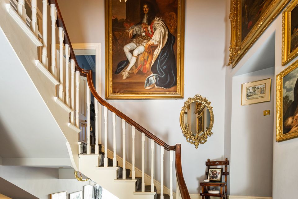 Artwork adorns the commanding winding stairwell