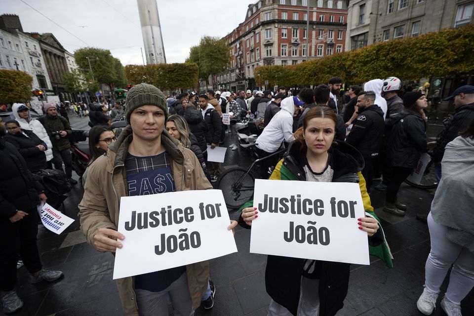 Members of the Brazilian community gather outside The Spire in Dublin ahead of march through the city centre after a delivery driver was seriously injured in a collision with a garda car on the M50 on Saturday (Niall Carson/PA)