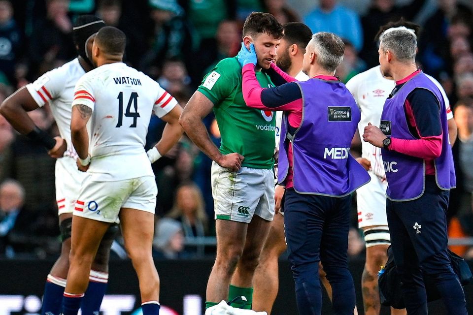 Ireland's Hugo Keenan receives medical treatment before leaving the pitch for a HIA after a tackle by England's Freddie Steward. Photo: Seb Daly/Sportsfile