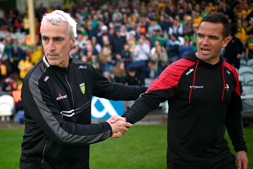 Donegal manager Jim McGuinness, left, shakes hands with Louth manager Ger Brennan after the All-Ireland SFC preliminary quarter-final at MacCumhaill Park in Ballybofey, Donegal. Photo: Ramsey Cardy/Sportsfile