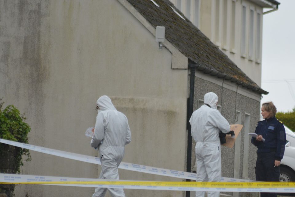Officers from the Garda Technical Bureau carry out a search in Knockanure on Monday morning. 