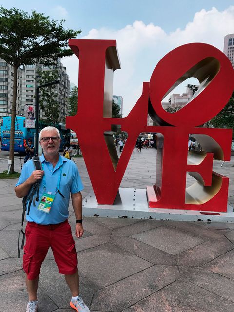 Beatles fan John simply couldn't resist having a photo with giant LOVE sculpture