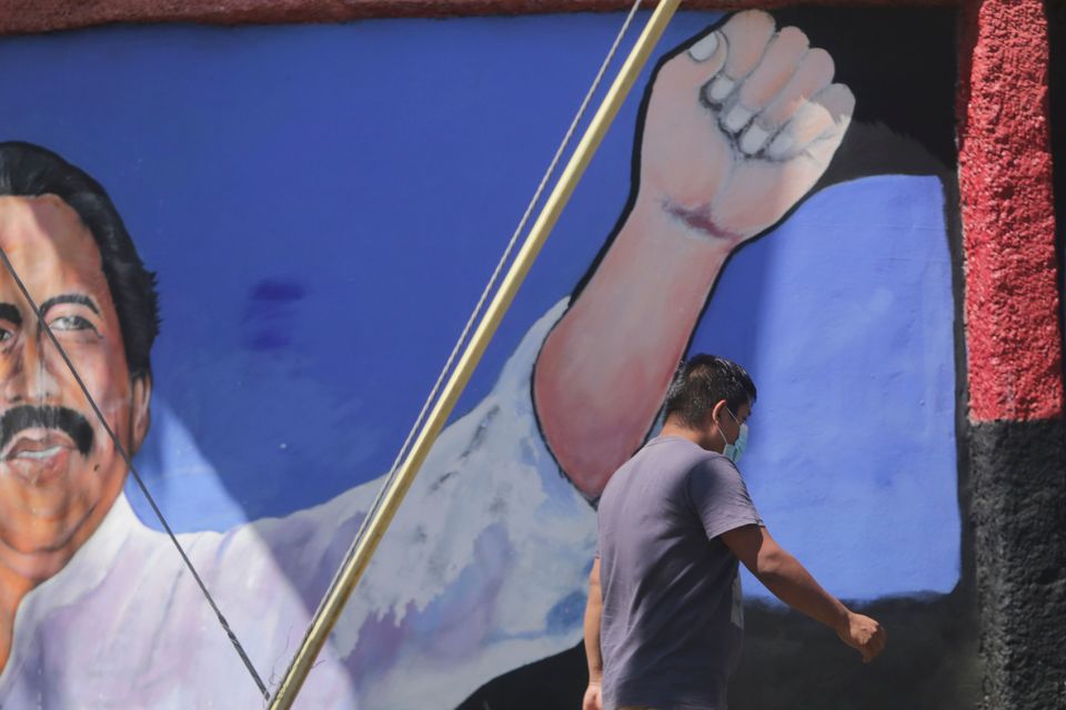 A man walks past a mural of Nicaraguan President Daniel Ortega (Andres Nunes/AP)