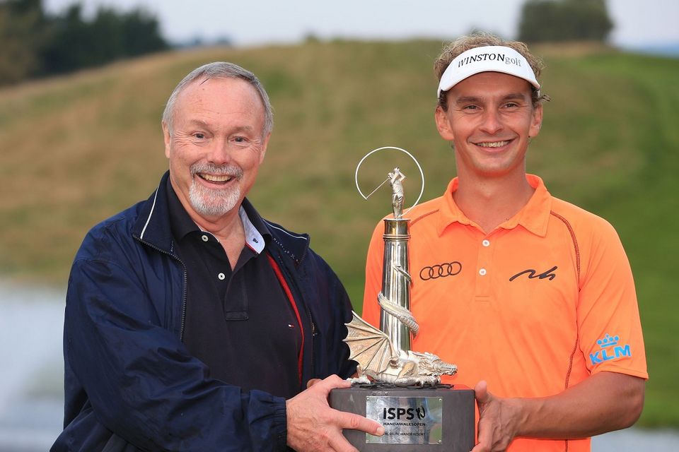 Netherland's Joost Luiten holds the trophy after winning The ISPS Handa Welsh Open with owner of Celtic Manor golf Club, Sir Terry Matthews (left) during day four of the 2014 ISPS Handa Welsh Open at Celtic Manor, Newport.