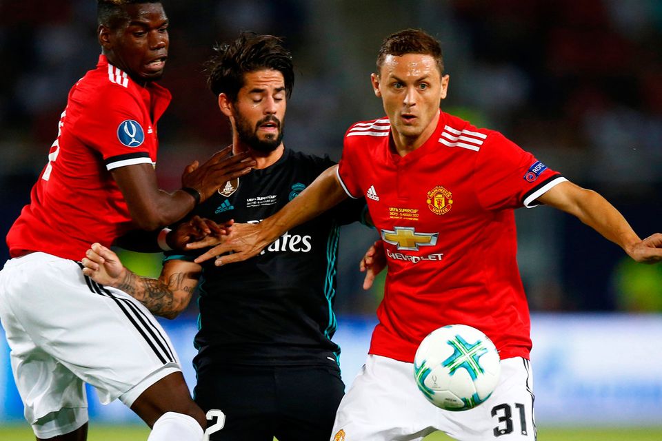 Real Madrid’s Isco in action with Manchester United's Nemanja Matic and Paul Pogba   REUTERS/Peter Cziborra