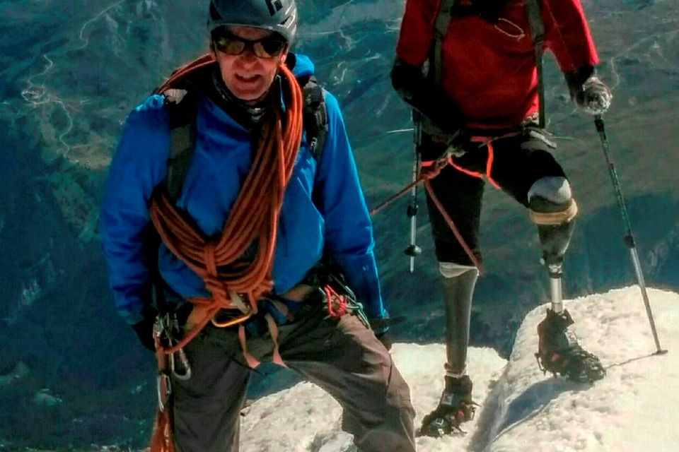 Quadruple amputee mountaineer Jamie Andrew,  right,  and  Steve James, who accompanied him,  stand on Matterhorn Mountain in Switzerland. (Courtesy of Jamie Andrew via AP)