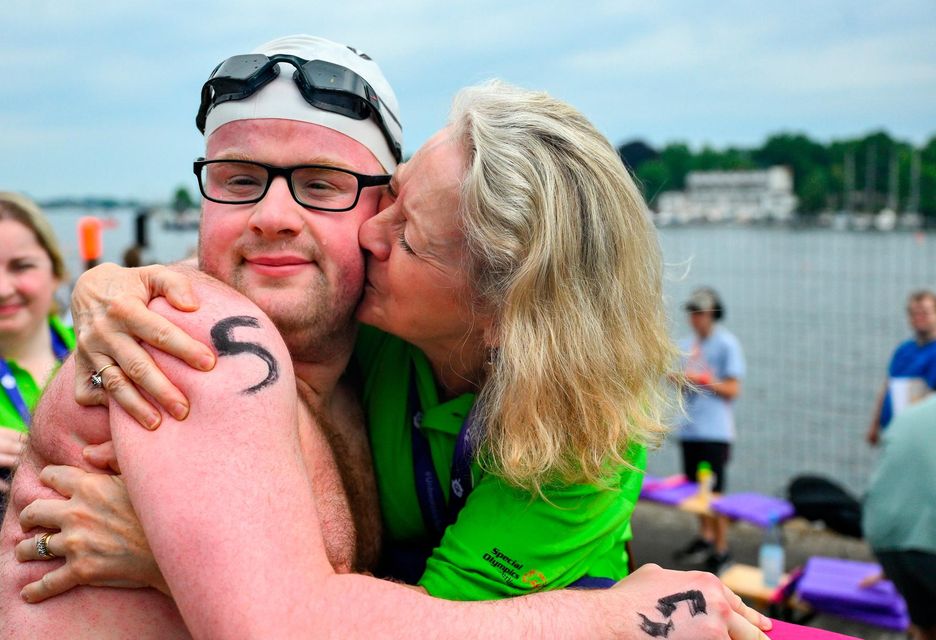 19 June 2023; Team Ireland's Eoin O'Connell, a member of D6 Special Olympics Club, from Dundrum, Dublin, with his mother Marie after the Open Water Swim 1,500m on day three of the World Special Olympic Games 2023 at the Grünau regatta course in Berlin, Germany. Photo by Ray McManus/Sportsfile 