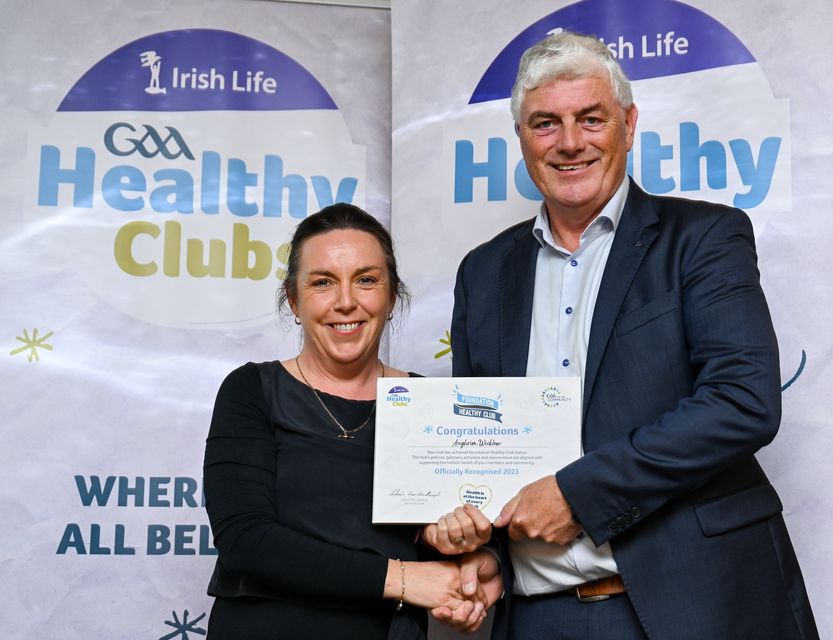 Leinster GAA's Health and Welbeing Chairperson Dave Murray presents Majella O'Shea of the Aughrim GAA Club with their foundation award.  