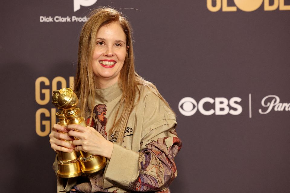 Justine Triet poses with the awards for Best Motion Picture – Non-English Language and Best Screenplay for "Anatomy of a Fall" during the 81st Annual Golden Globe Awards in Beverly Hills, California, U.S., January 7, 2024. REUTERS/Mario Anzuoni