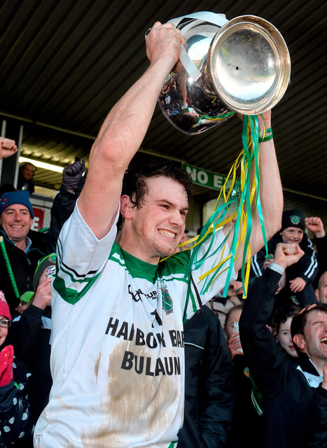 Sarsfields captain Joe Cooney lifts the cup after the game