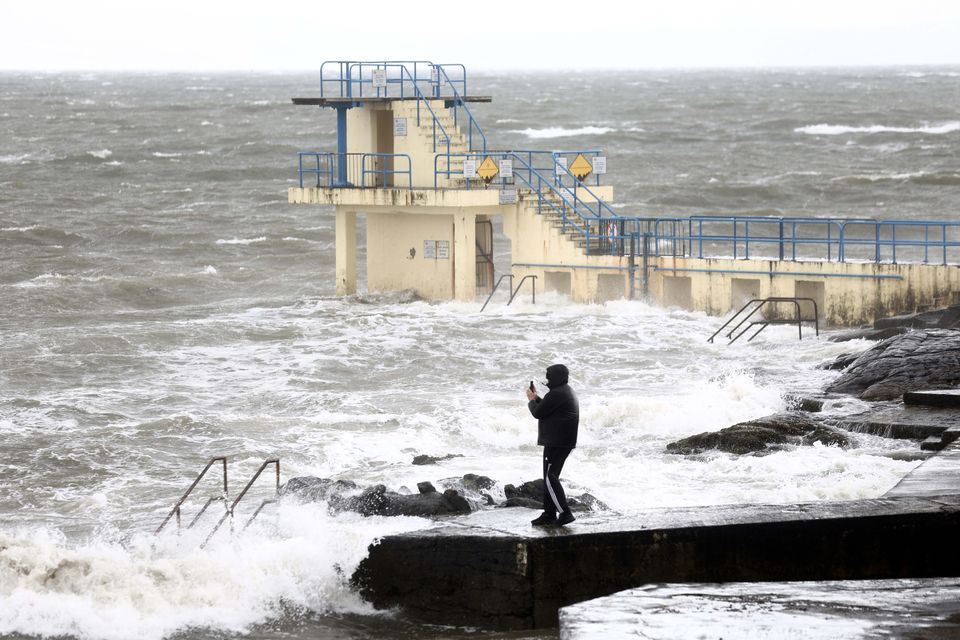 06/04/2024 Galway Ireland. People taking pictures with their mobile phones as high waves hit the coastline at Salthill as Storm Kathleen comes to Ireland. Photo: Sasko Lazarov/© RollingNews.ie