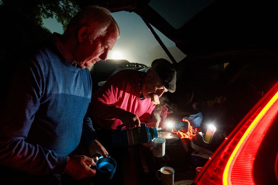 Brian Conneely and Kevin Cunniffe from Galway gets an early morning cup of tea from the boot of his car on opening day of the National Ploughing Championships. Photo: Mark Condren