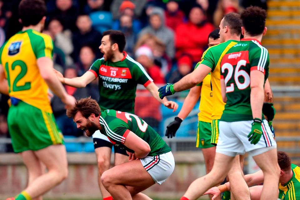 Mayo’s Aidan O’Shea falls to the ground in the incident which saw Donegal’s Eamonn Doherty (right) sent off at MacHale Park. Photo: Stephen McCarthy/Sportsfile