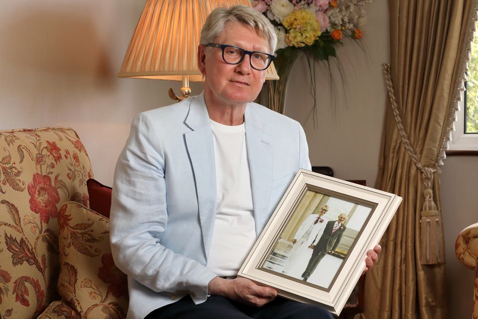 Paddy Crosbie holds a photograph from his wedding day of himself and his partner Derek Simpson, who was diagnosed with early stage Alzheimer's. Photo: Frank McGrath