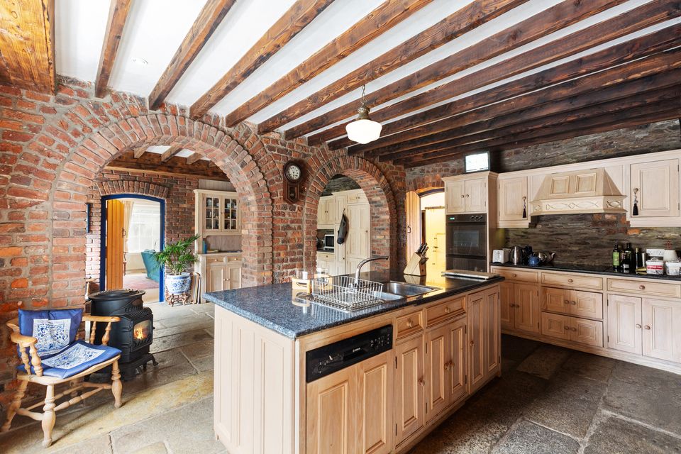 The kitchen with exposed ceiling beams