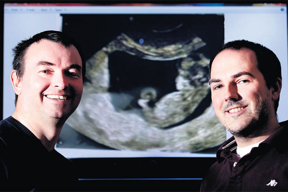 PROUD DADS TO BE: Patrick O'Keeffe, left, and his Spanish husband Alvaro Gonzalez with the scan of their surrogate baby. Alvaro's parents in Spain
mortgaged a holiday home to raise the tens of thousands needed to have a surrogate baby in the United States. Photo: David Conachy