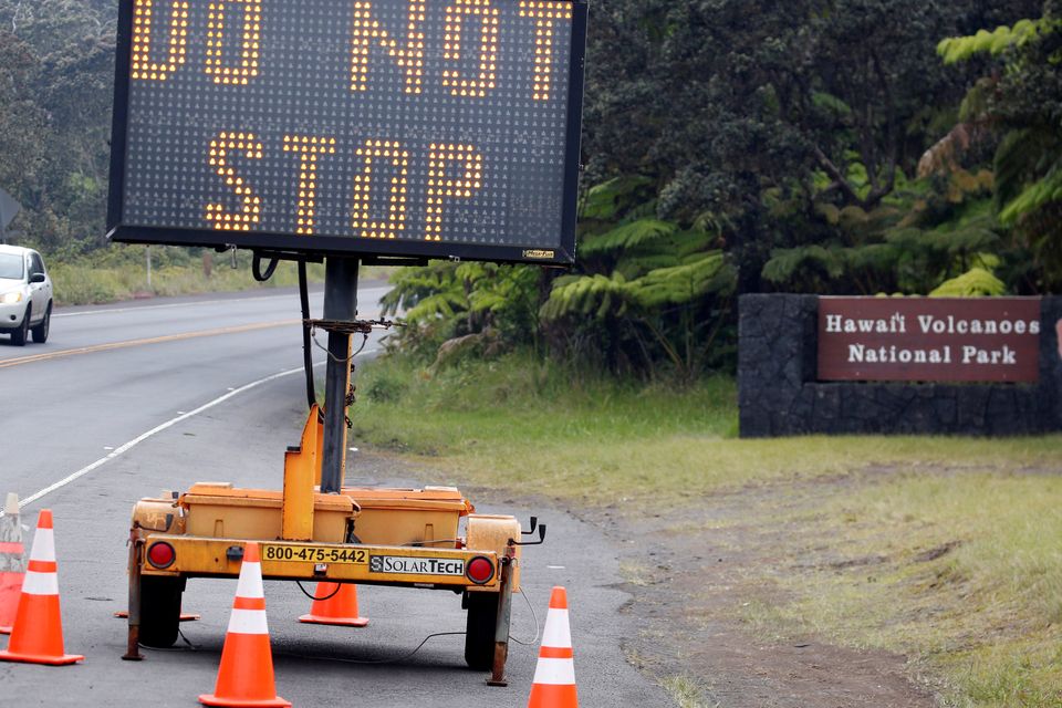 A highway sign near Hawaii Volcanoes National Park warns motorists not to stop during ongoing eruptions of the Kilauea Volcano in Hawaii, U.S., May 16, 2018.  REUTERS/Terray Sylvester