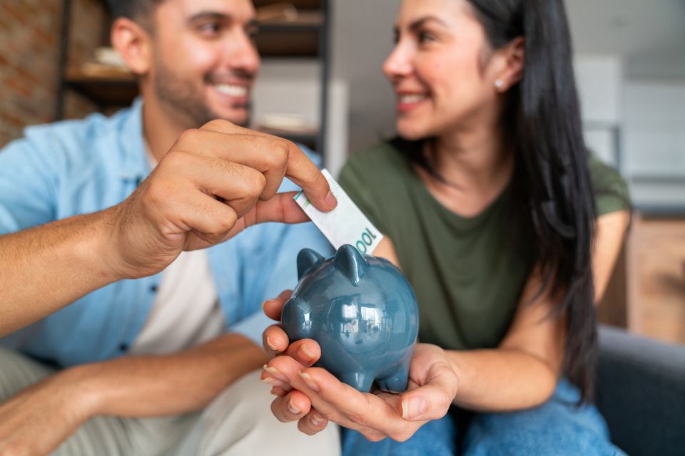 Couple saving for a house. Picture posed