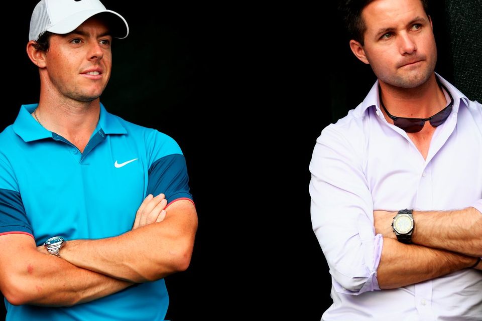 Rory McIlroy of Northern Ireland looks on, with his agent Sean O'Flaherty after the final day of the Abu Dhabi HSBC Golf Championship at Abu Dhabi Golf Club on January 18, 2015 in Abu Dhabi, United Arab Emirates.  (Photo by Matthew Lewis/Getty Images)