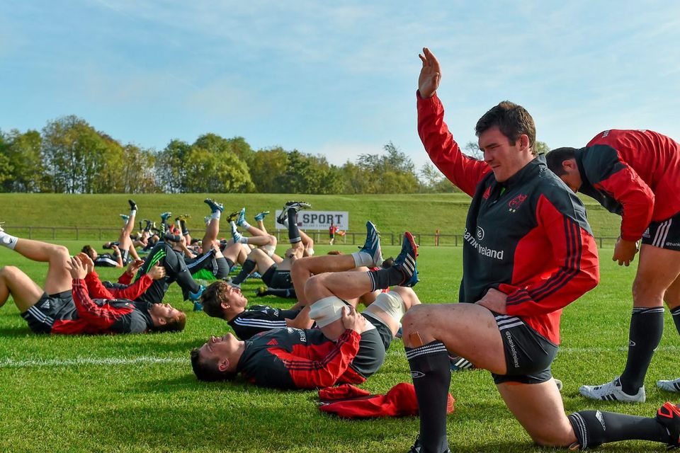 Munster's Peter O'Mahony stretches during squad training