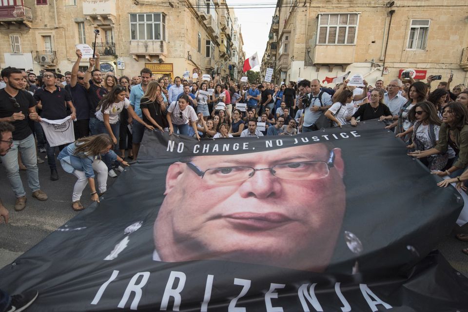 A banner with a photo of Malta police commissioner Lawrence Cutajar outside the Malta police headquarters after a rally to honour Daphne Caruana Galizia (AP Photo/Rene Rossignaud)