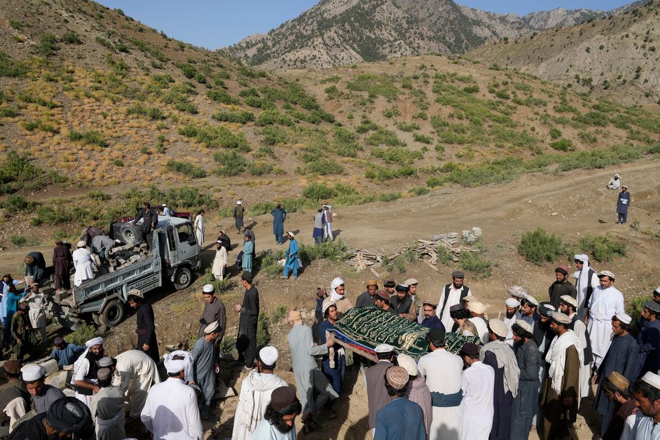 Afghans carry a relative killed in an earthquake to a burial site in Gayan village, in Paktika province (Ebrahim Nooroozi/AP)