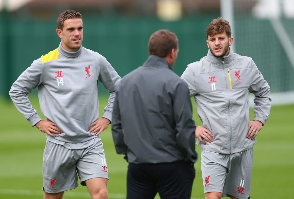 Liverpool manager Brendan Rodgers has a word with L-R Jordan Henderson and Adam Lallana during a training session ahead of their UEFA Champions League group B match against PFC Ludogorets