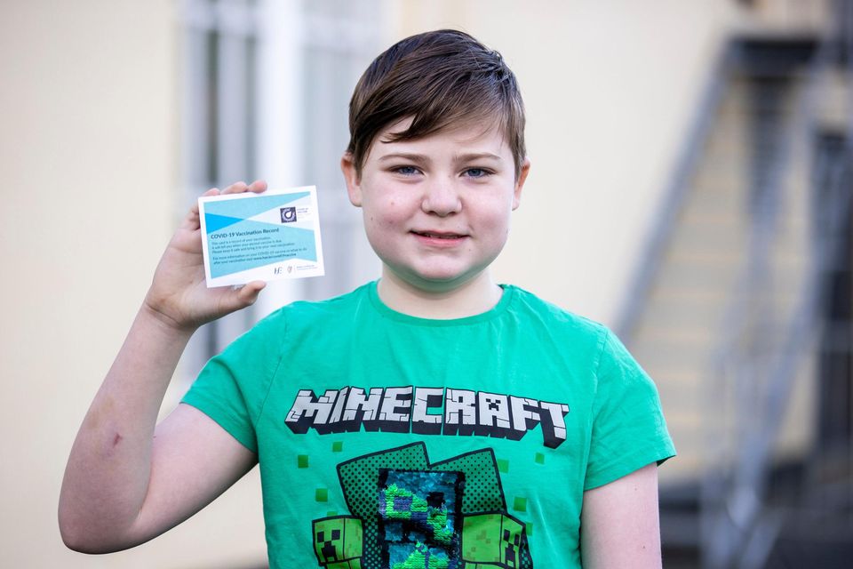 Leo McGeough (12), from Castleblaney, holds his vaccination record card after getting his second jab in Co Monaghan. Photo: Liam McBurney/PA