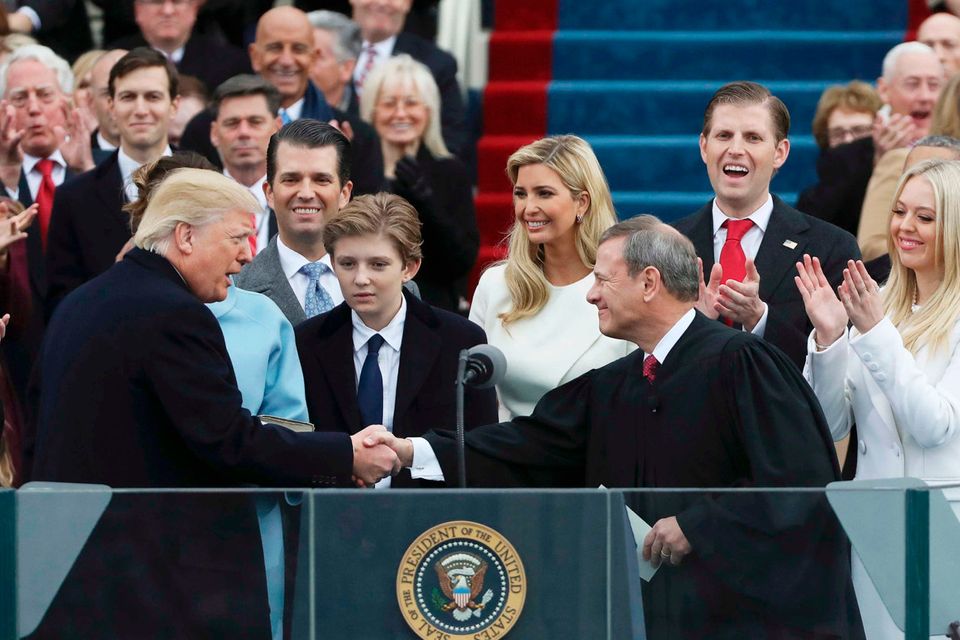 President Donald Trump shakes hands with Justice John Roberts (R) after taking the oath at inauguration ceremonies swearing in Trump as the 45th president of the United States on the West front of the U.S. Capitol in Washington, U.S., January 20, 2017. REUTERS/Carlos Barria