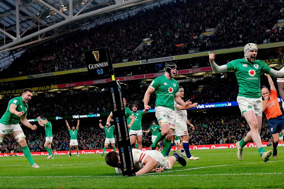 Ireland players, from left, Jack Conan, James Ryan, and Mack Hansen celebrate their side's third try, scored by teammate Dan Sheehan, not pictured, during the Guinness Six Nations Rugby Championship match between Ireland and England at the Aviva Stadium in Dublin.