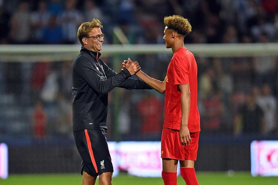 Liverpool manager Jurgen Klopp embraces goalkeeper Shamal George after he played up front in the friendly win against Hudderfield. Getty
